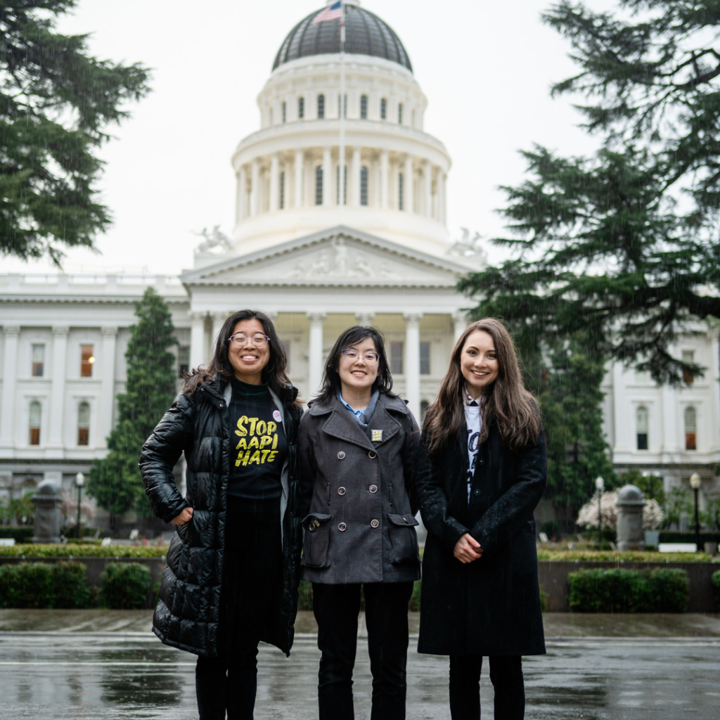 A picture of three Stop AAPI Hate staff in front of the California state capitol.